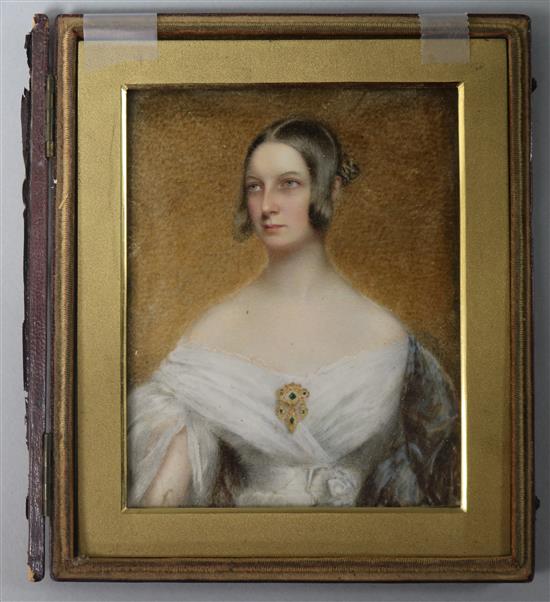 Early 19th century English School Portrait miniature of a lady, half length wearing a white gown and emerald and gold brooch 11 x 9cm
